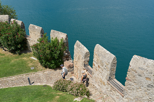 Malcesine, Italy – August 02, 2023: View from the tower of the Scaligerburg, Scaliger Castle on the shore of Lake Garda in Malcesine to the complex below