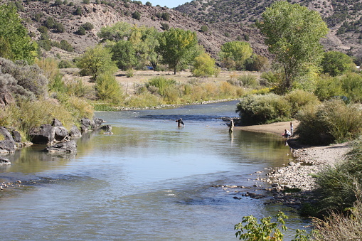 Fly fishermen in a river in New Mexico