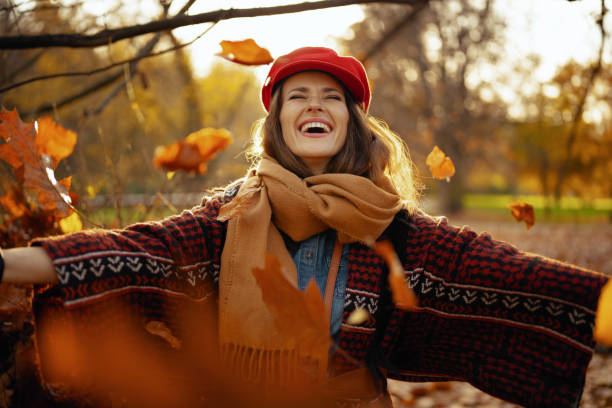 istock happy modern woman in red hat with scarf rejoicing 1634240920