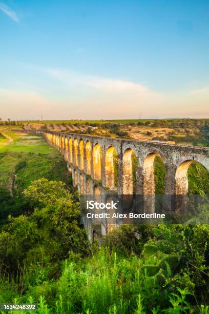 Aqueduct Between Mountains At Sunrise With Cloudy Sky In Arcos Del Sitio In Tepotzotlan State Of Mexico Stock Photo - Download Image Now