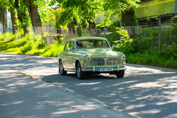 Borås, Sweden - May 28 2023: Green 1966 Volvo Amazon classic car on a small road.