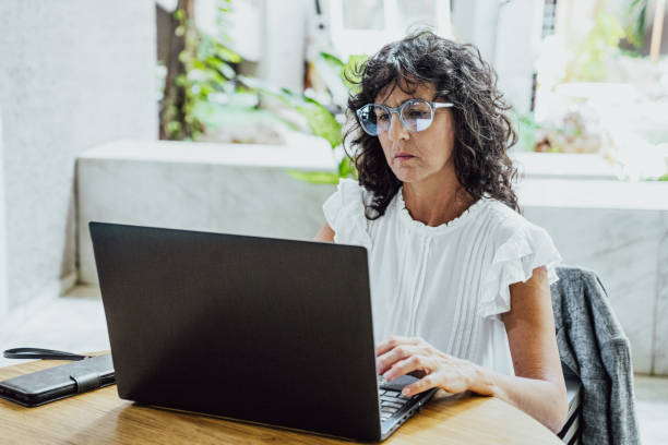 Mature businesswoman working using laptop