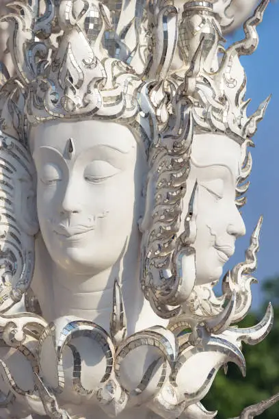 Photo of Chiang Rai, Thailand - December 2022: Sculptural composition faces of god at Wat Rong Khun temple