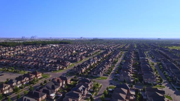 Panoramic view at established neighbourhood with town home cottage style houses in Canada. Top aerial view at middle class family homes with large backyard and green front yards. Very clean area. stock photo
