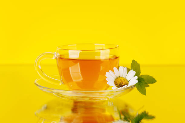 Soothing herbal tea blend with mint and chamomile. On yellow background