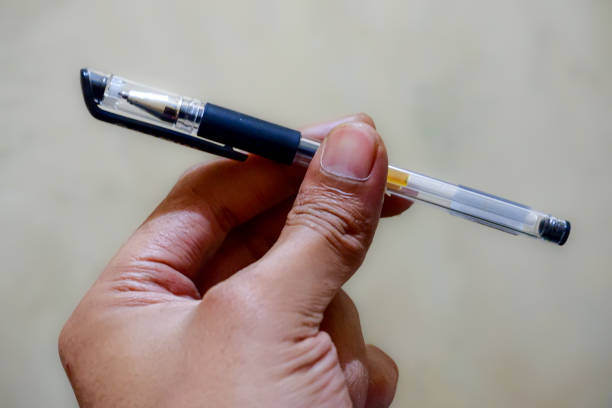 istock A hand holding a ballpoint pen. 1634314527