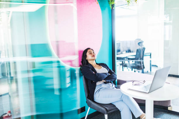istock Young asian woman relaxing while working in modern office space 1634333303