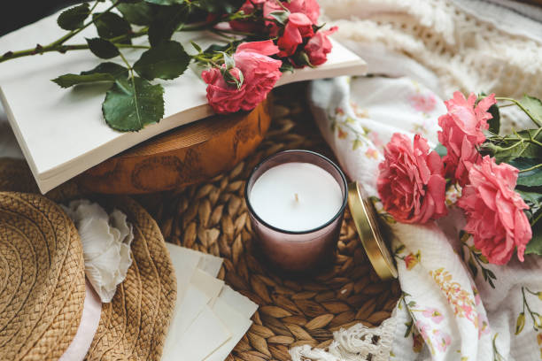 istock Candle in an aesthetic spring interior with roses 1634338406