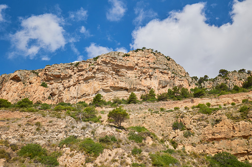 A rock against a blue sky. Near the beach Cala del Moraig, Spain, Costa Blanca