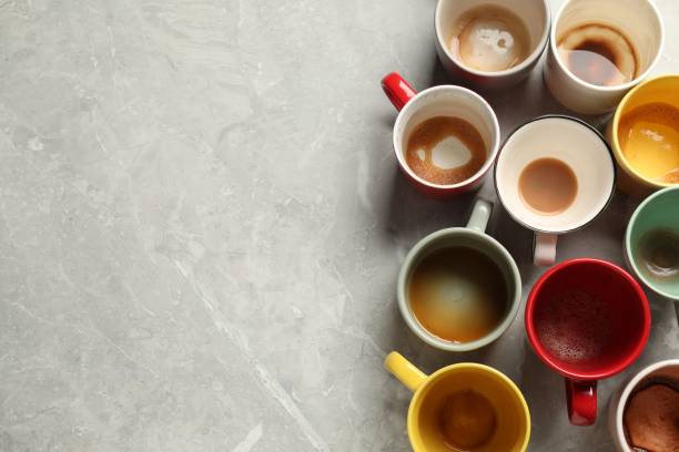 istock Many dirty cups after different coffee drinks on light grey marble table, flat lay. Space for text 1634363662