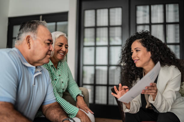 Financial advisor having a meeting with senior couple at home Financial advisor having a meeting with senior couple at home attorney stock pictures, royalty-free photos & images