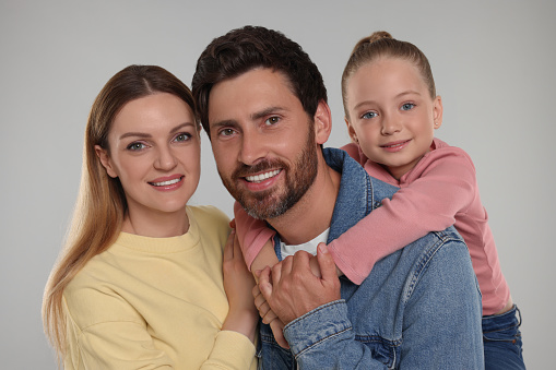 Portrait of happy family on light grey background