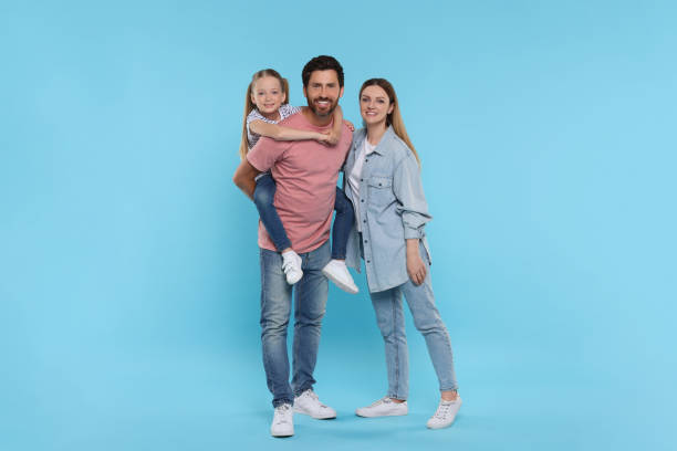 istock Happy family together on light blue background 1634427056