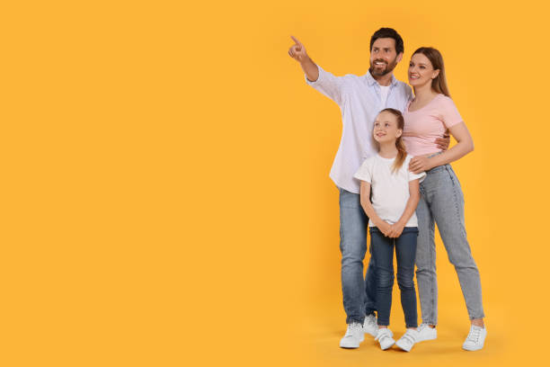 istock Happy family on orange background, space for text 1634430799