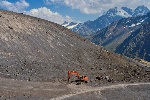 construction equipment works on the mountainside