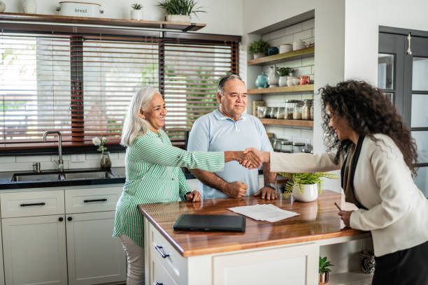 istock Financial advisor shaking hands with customer in the kitchen at home 1634509169
