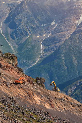 construction equipment works on the mountainside
