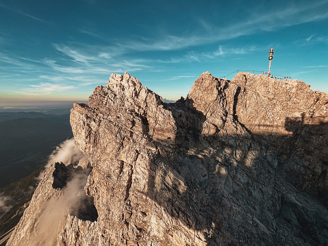 Dramatic landscape as viewed from Mountain Zugspitze with its summit cross at Sunset, Germany