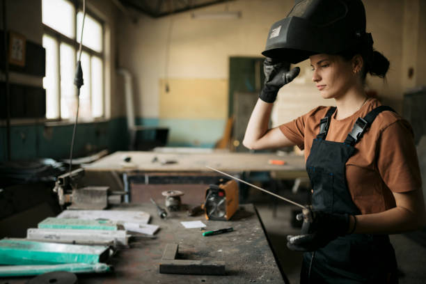 istock Caucasian young woman welding in workshop 1634602826