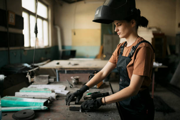istock Young woman welder working in a small metal workshop 1634602838