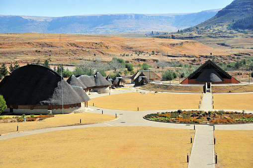 Thaba Bosiu, Motloang, Lesotho: Basotho traditional building at Thaba Bosiu Cultural Village, seen from above - built to showcase Lesotho’s traditional and cultural heritage, museum and full-scale recreation of a traditional village - the area was once the stronghold of King Moshoeshoe I, the kingdom’s founding father. View from the road to Maseru.