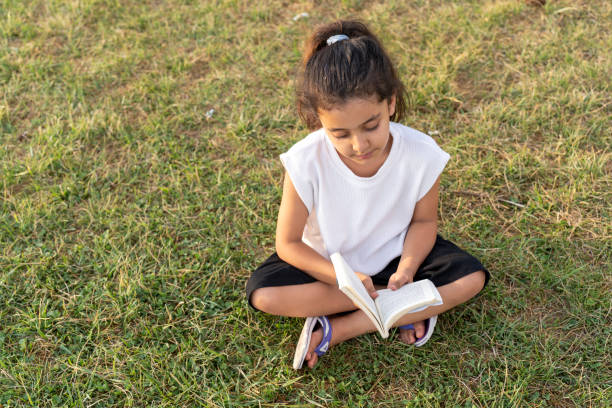 istock Girl reading a book. 1634631566