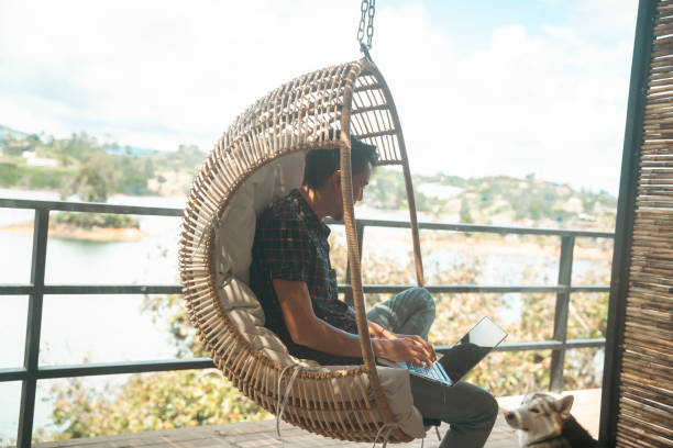A Young man working remotely while traveling with his dog living a nomadic lifestyle