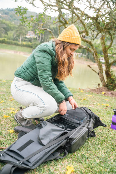 istock A young woman unpacking next to her tent 1634650951