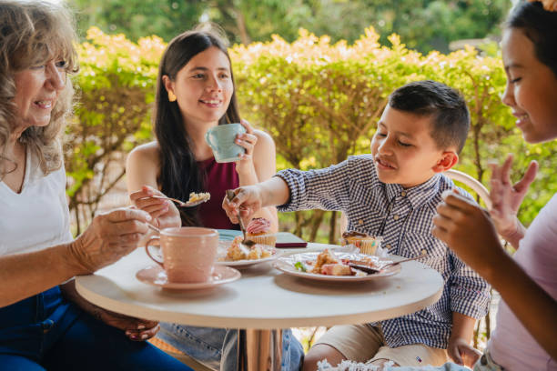istock Multi-generation family talking and having fun in a cafe while drinking coffee stock video 1634653079