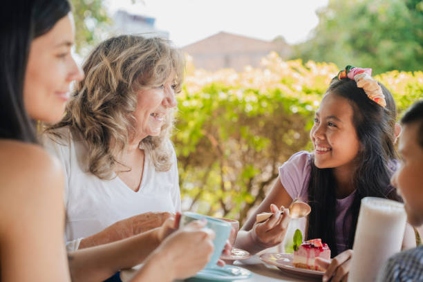 istock Multi-generation family talking and having fun in a bakery while drinking coffee stock video 1634654139