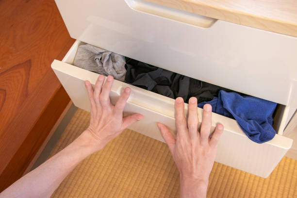 istock push in a drawer full of clothes with both hands 1634677125