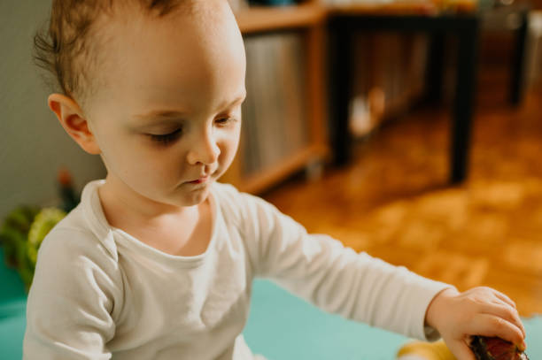 istock Close up of an interested child discovering through the game while sitting at home. 1634701065