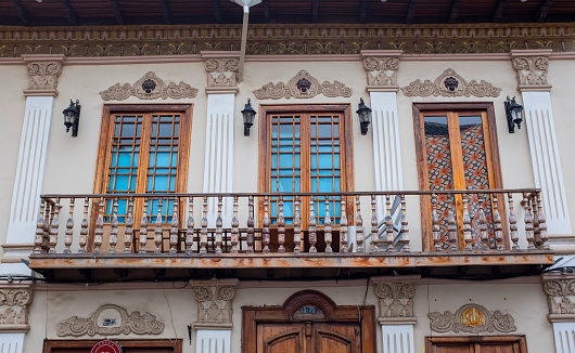 An ornate balcony and traditional architecture of a residential house in the city of Cuenca