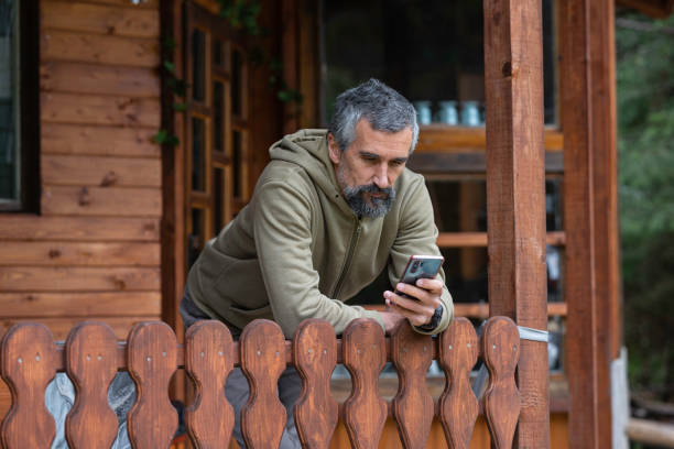 istock Cabin getaway. Man enjoys a log cabin retreat. 1634740710