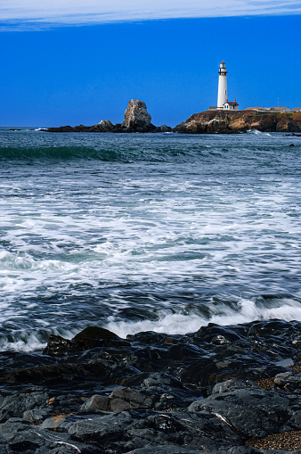 Pigeon Point Lighthouse in the distance along the rocky shore of the Northern California coast.  This is the tallest lighthouse on the West Coast of the United States.

Taken from Pigeon Point Light Station State Historic Park