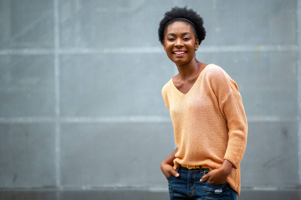 istock smiling young black woman against gray background 1634747173