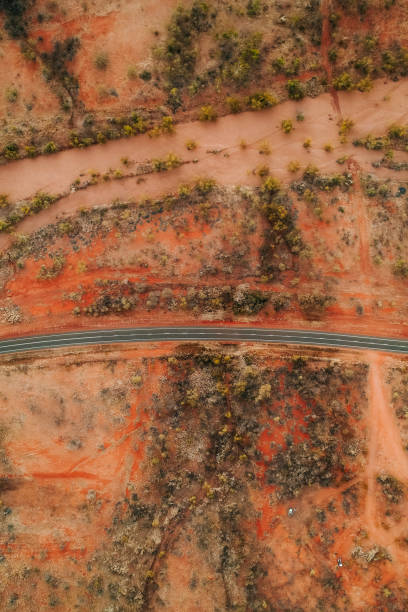 istock Aerial view of a road passing through the outback 1634788695