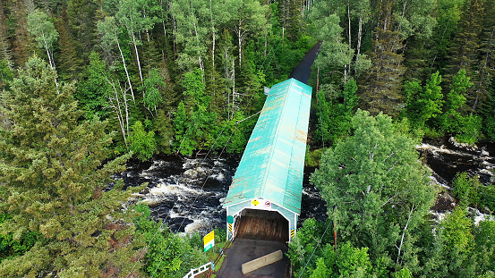 An aerial scene of Lac Ha! Ha! Covered Bridge in Quebec, Canada