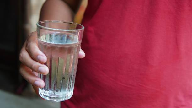 istock someone offering a glass of water 1634826043