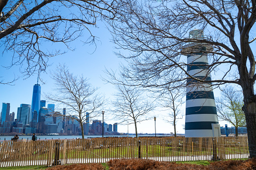 Wide angle image of LeFrak Lighthouse with a view of lower Manhattan.