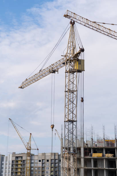 istock crane and a building under construction against a blue sky background 1634924921