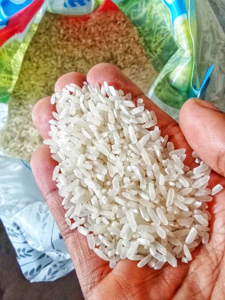Rice Handful of rice in hand jasmine rice stock pictures, royalty-free photos & images