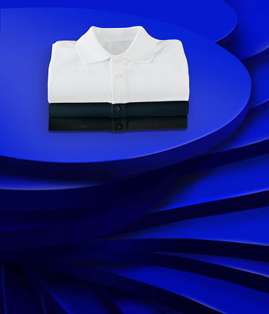 Folded shirts on a chic blue layered background