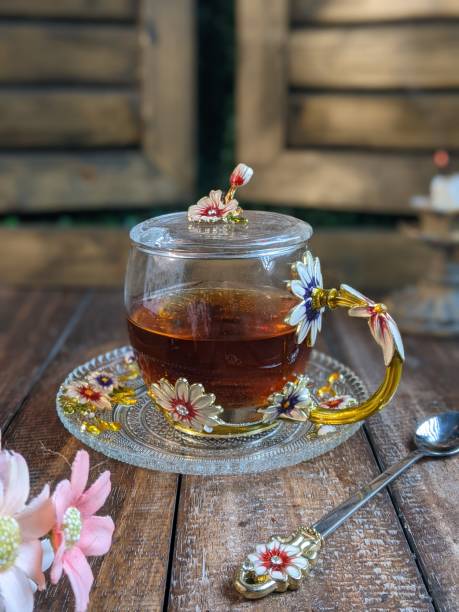 A Cup of freshly brewed black tea,escaping steam,warm soft light, darker background.