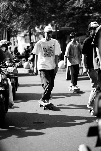 skateboarders or skaters get together and play on the street in freestyle, celebrating world skateboard day. : Yogyakarta, Indonesia - 21 June 2023