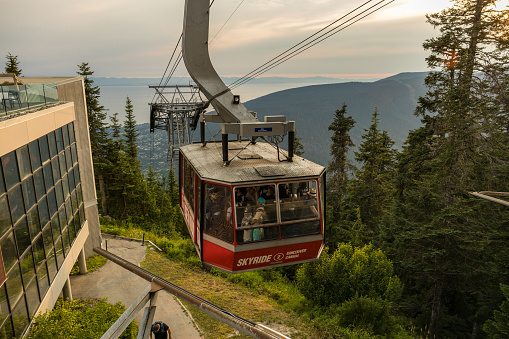 Vancouver, Canada - August 5,2023: Scenic view of Grouse Mountain's Skyride gondola set against a stunning sunset backdrop