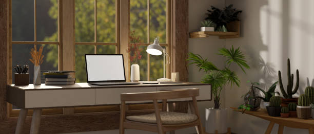 istock A cozy, minimalist home workspace with a laptop on a table against the window 1634999009