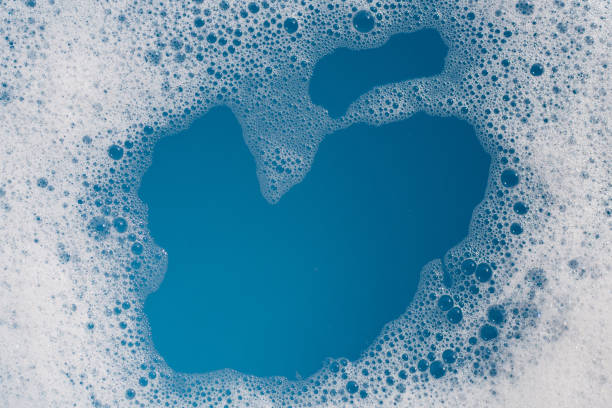istock Detergent foam bubble on water. Blue background, Soap sud 1635042183