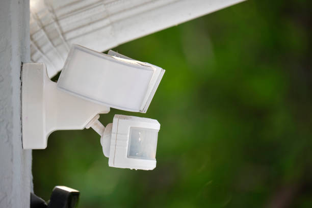 istock Motion sensor with light detector mounted on exterior wall of private house as part of security system 1635044383