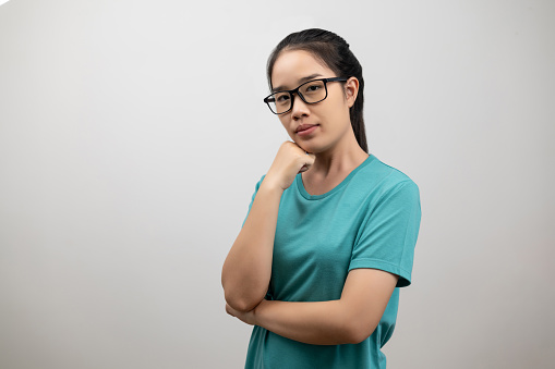 Portrait of young Asian woman patients neurocrine disease in green t-shirt on light gray background, classic congenital adrenal hyperplasia, rare hormonal disorders, nervous system medical concept